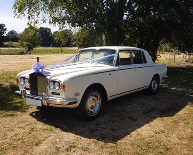 White 1974 Rolls-Royce Silver Shadow with wedding ribbons for rolls-royce car rental in Center City, MN