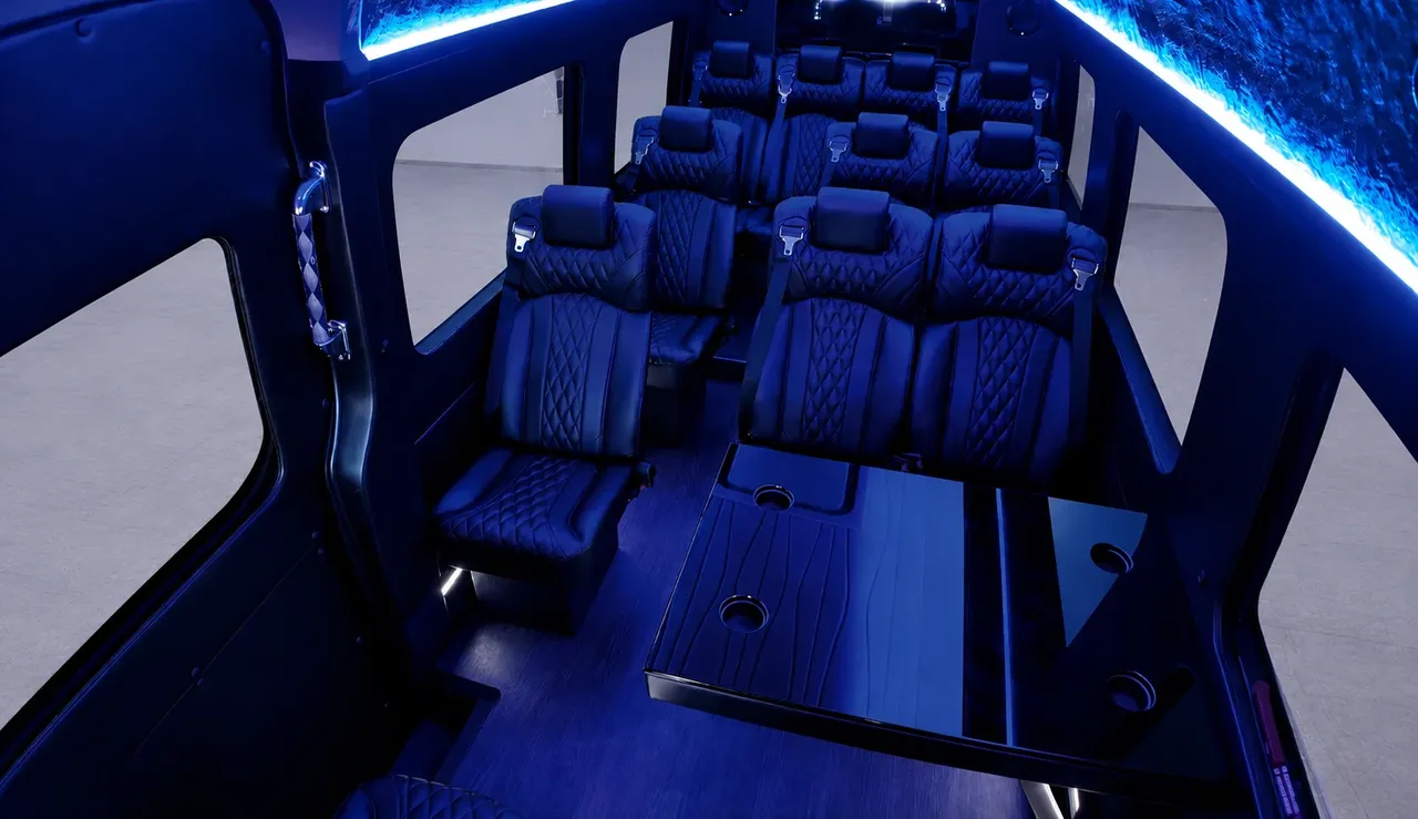 Black Luxury Sprinter Shuttle Van interior with captain's chairs, passenger tables and cup holders for winery tour transport in Woodland Hills, CA