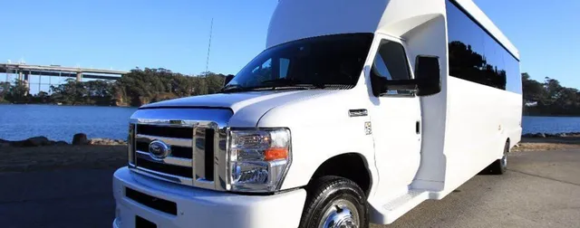 White Ford F-550 Party Bus exterior with tinted windows for party bus rental White Ford F-550 Party Bus exterior with tinted windows for party bus rental