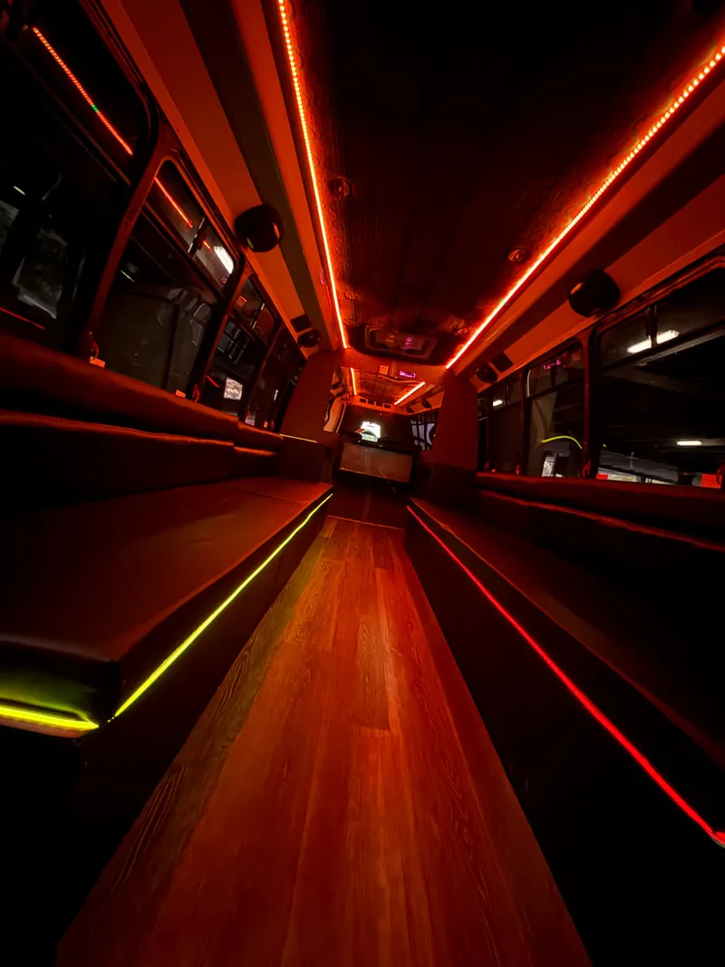 Ford E-450 Series Party Bus interior with perimeter lounge seating, LED accent lighting and LED ceiling lighting, photo 8 for party bus rental in North Attleboro, MA
