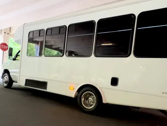 White Ford E-450 Series Party Bus exterior with tinted windows for party bus rental in North Attleboro, MA White Ford E-450 Series Party Bus exterior with tinted windows for party bus rental in North Attleboro, MA