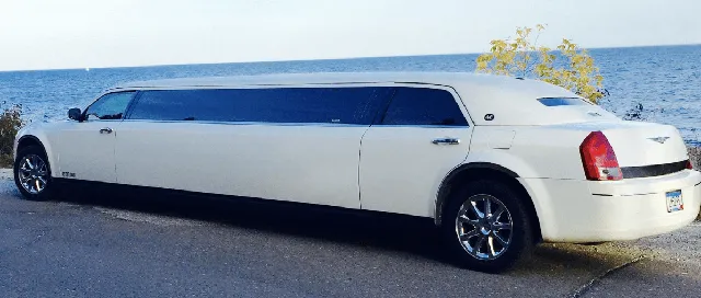 White C300 Limousine exterior with tinted windows, photo 3 for limo rental in North Dakota
