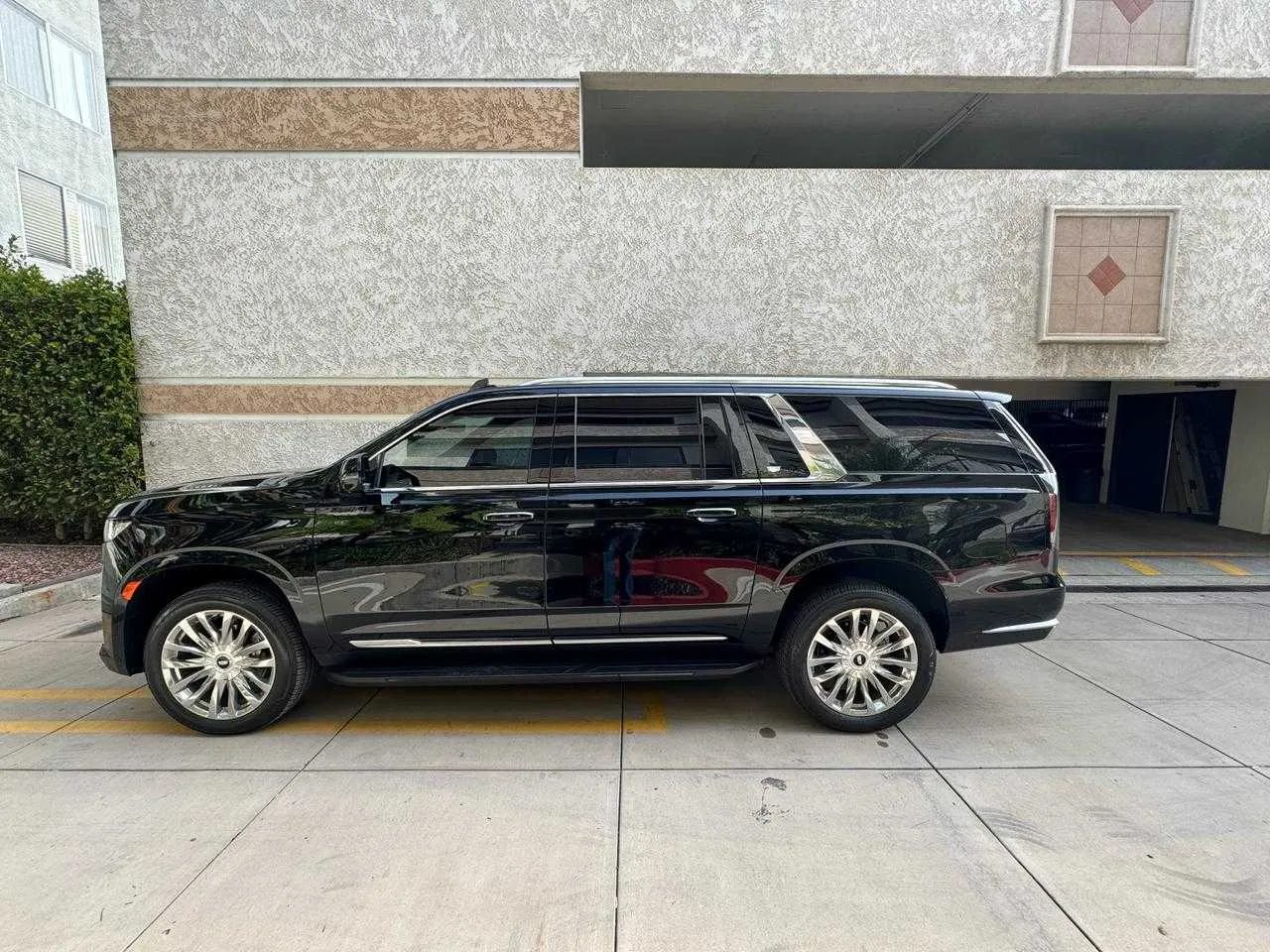 Black Cadillac Escalade exterior with running boards for airport transfers in Malibu, CA