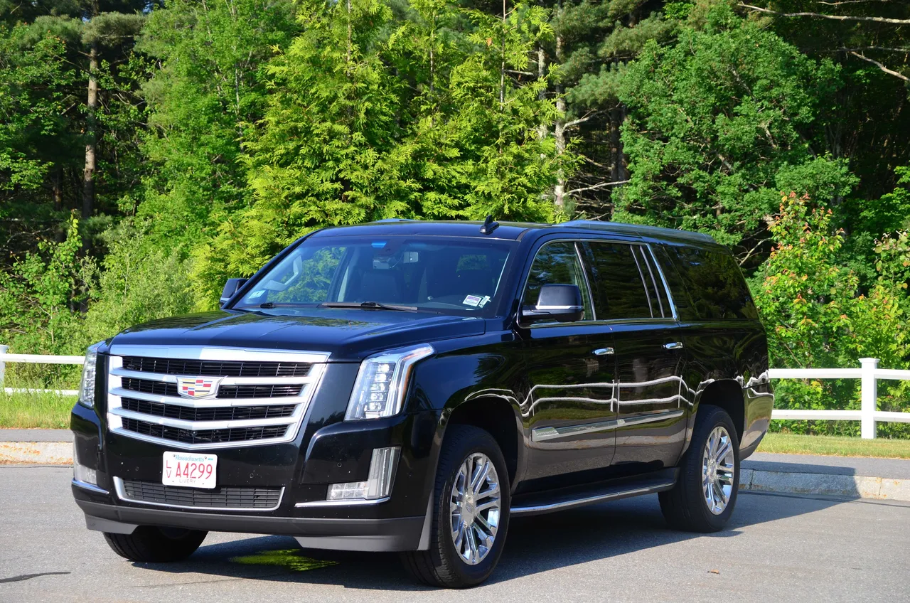 Black Cadillac Escalade exterior with running boards for airport transfers Black Cadillac Escalade exterior with running boards for airport transfers