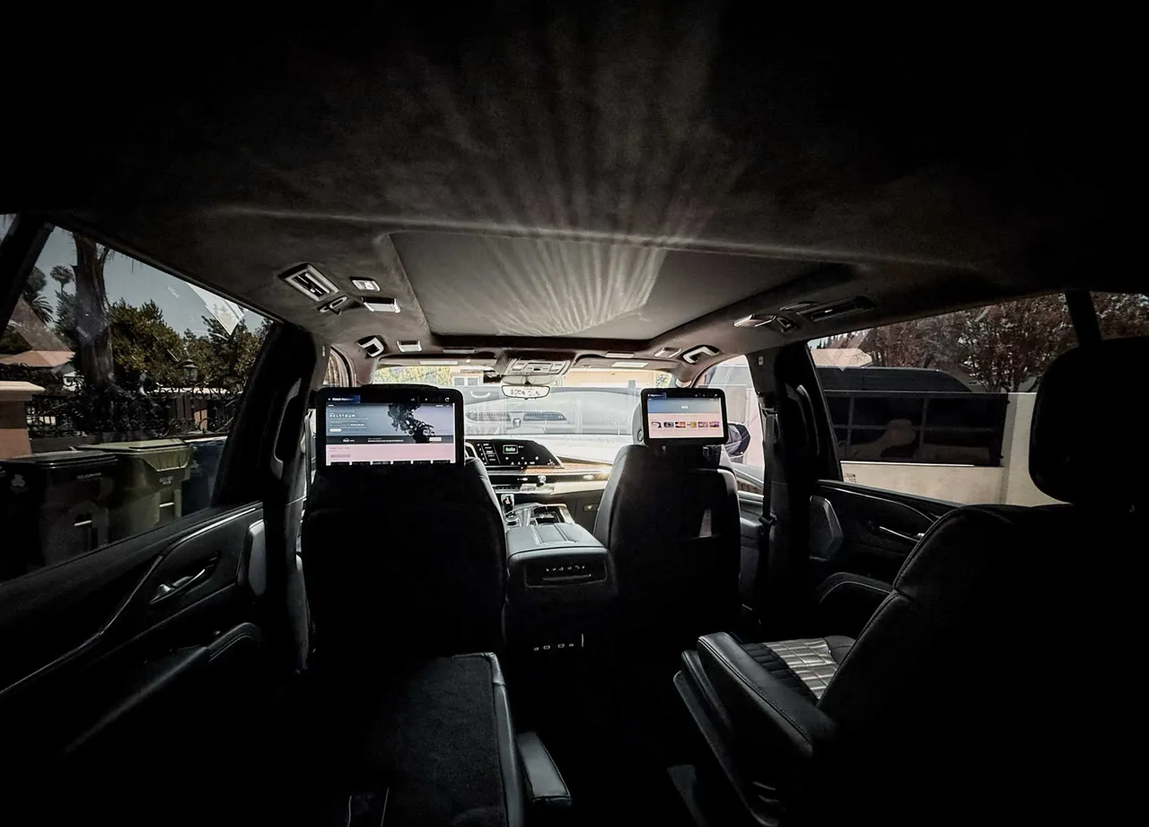 Cadillac Escalade interior with rear-seat entertainment screens for airport transfers in Venice, CA