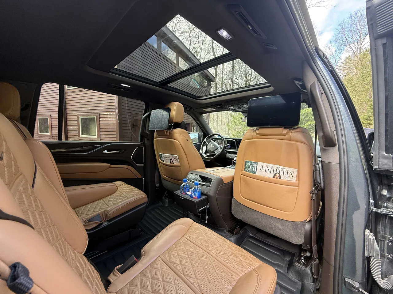 Cadillac Escalade interior with captain's chairs and rear-seat entertainment screens for airport transfers Cadillac Escalade interior with captain's chairs and rear-seat entertainment screens for airport transfers