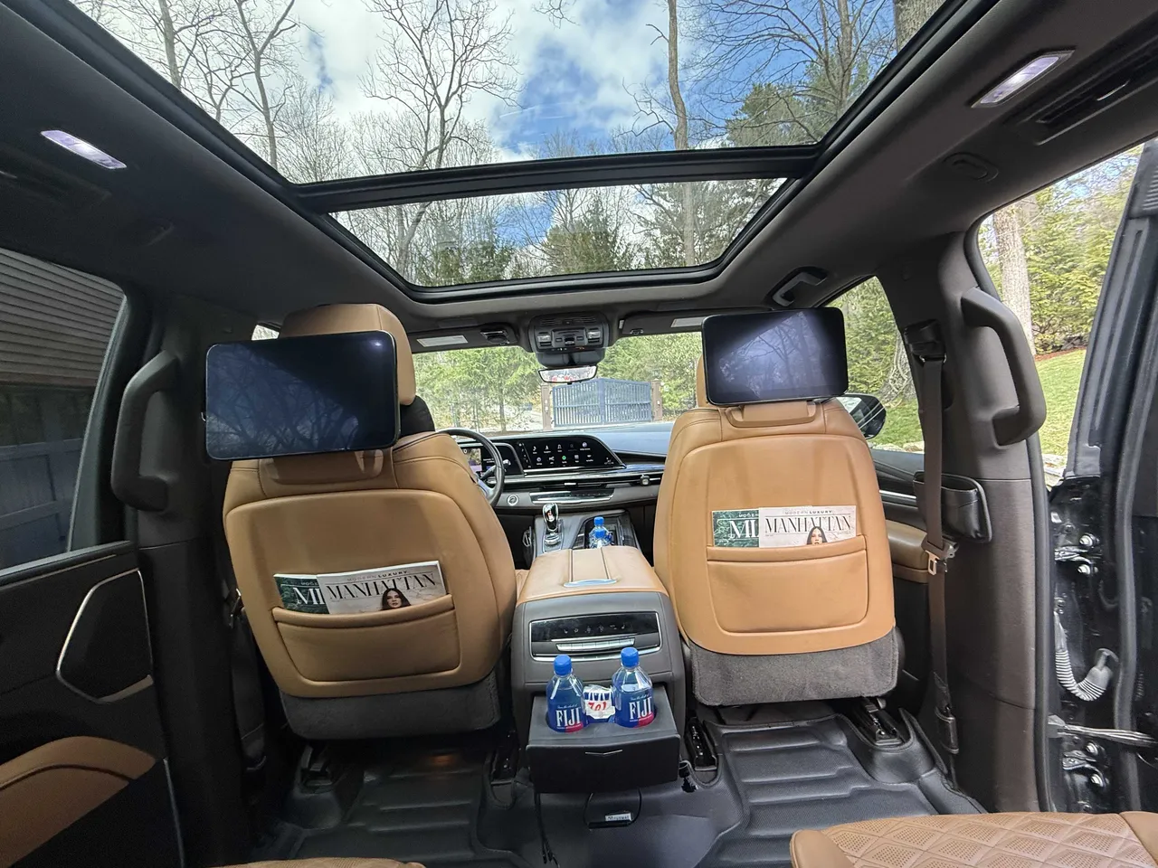 Cadillac Escalade interior with rear-seat entertainment screens for airport transfers Cadillac Escalade interior with rear-seat entertainment screens for airport transfers