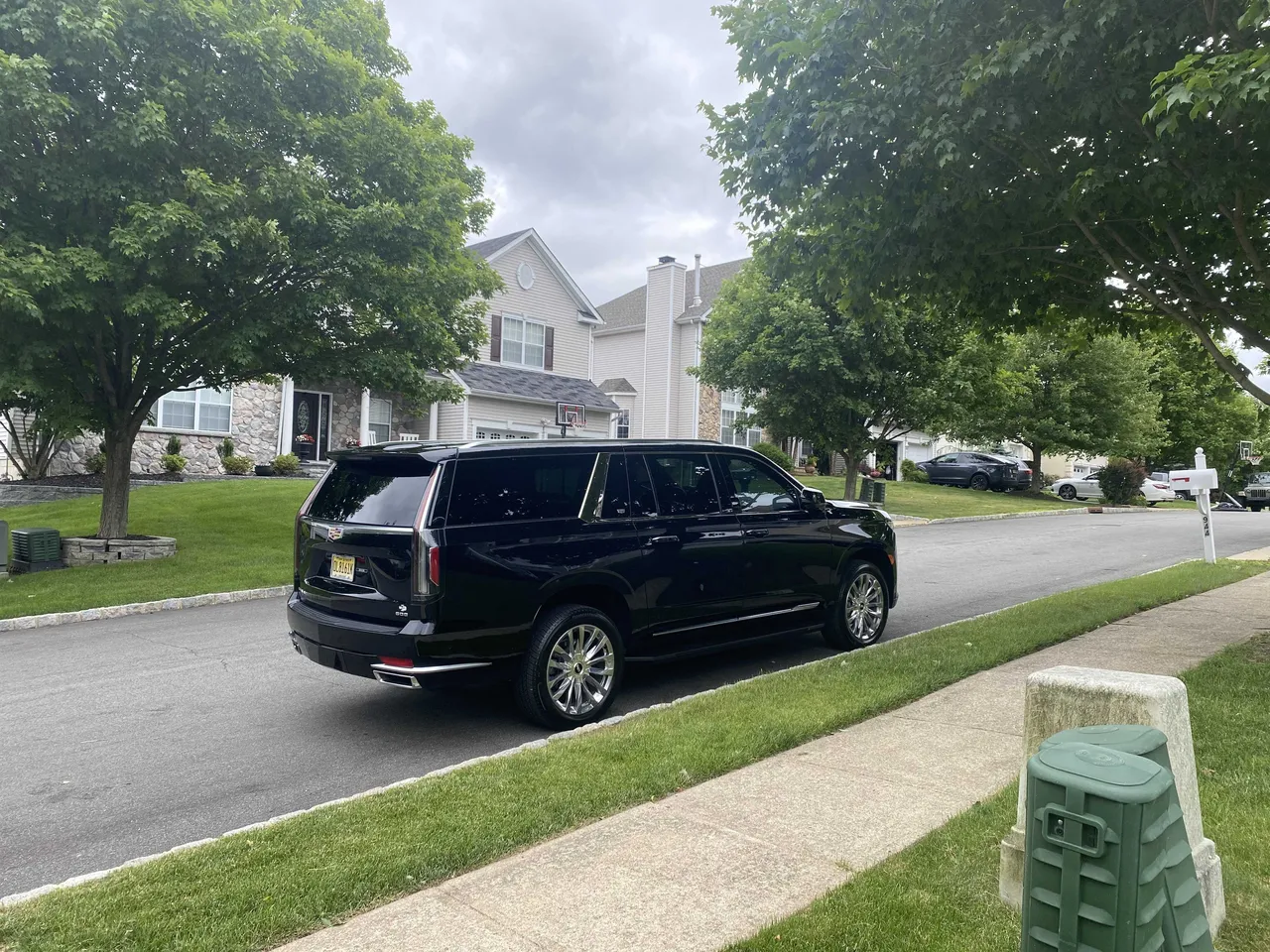 Black Cadillac Escalade exterior with tinted windows for airport transfers Black Cadillac Escalade exterior with tinted windows for airport transfers