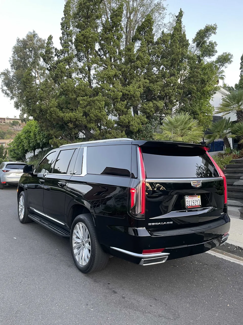 Black Cadillac Escalade exterior with tinted windows and running boards for cadillac escalade limo in Beverly Hills, CA