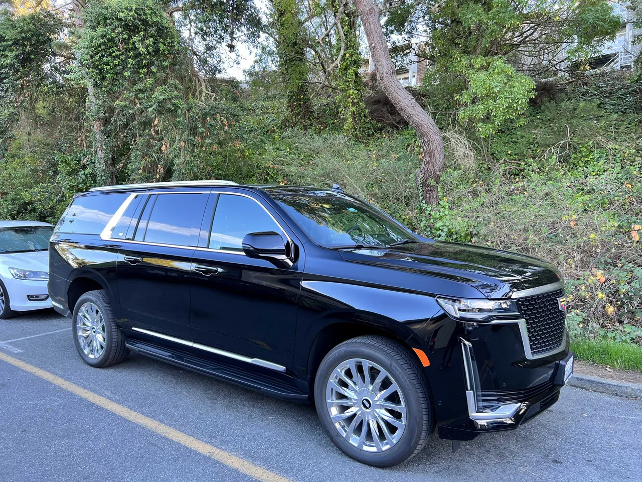 Black Cadillac Escalade 6 Pax with tinted windows and running boards for airport transfers in Marin County, CA