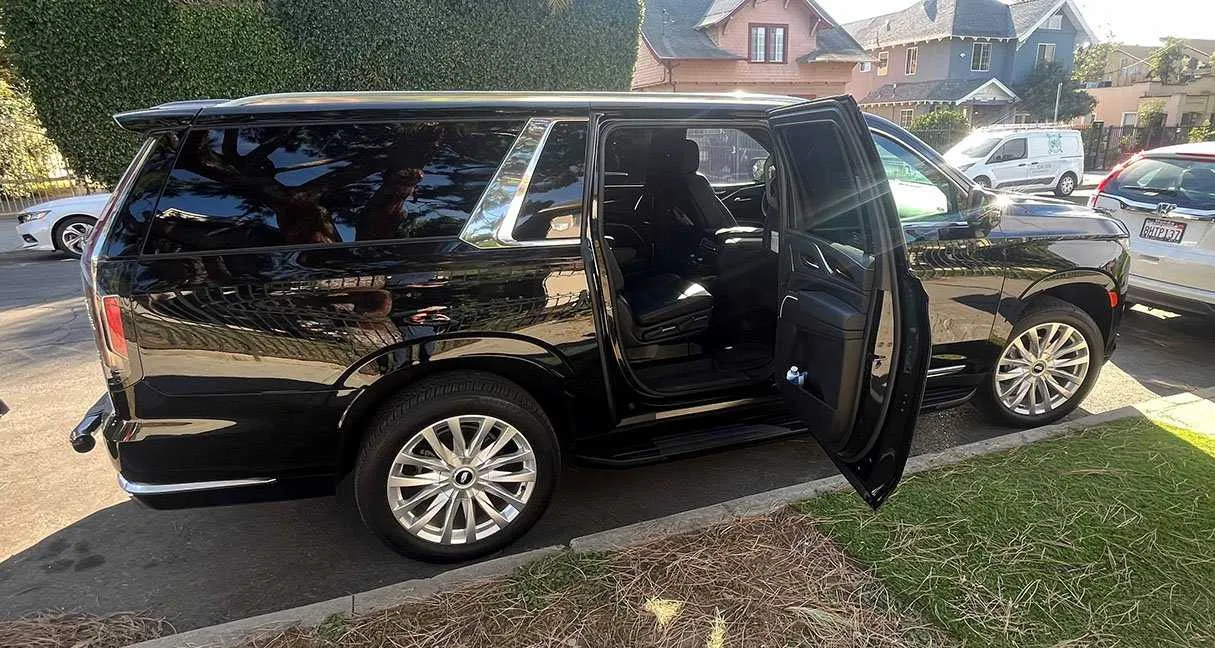 Black Cadillac Escalade exterior with running boards for cadillac escalade limo in Los Angeles, CA