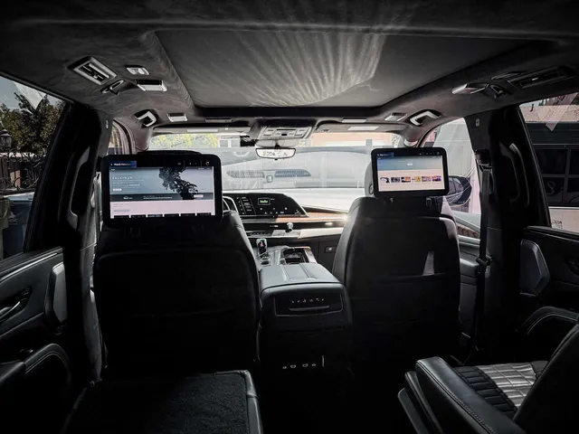 Cadillac Escalade interior with rear-seat entertainment screens for airport transfers Cadillac Escalade interior with rear-seat entertainment screens for airport transfers