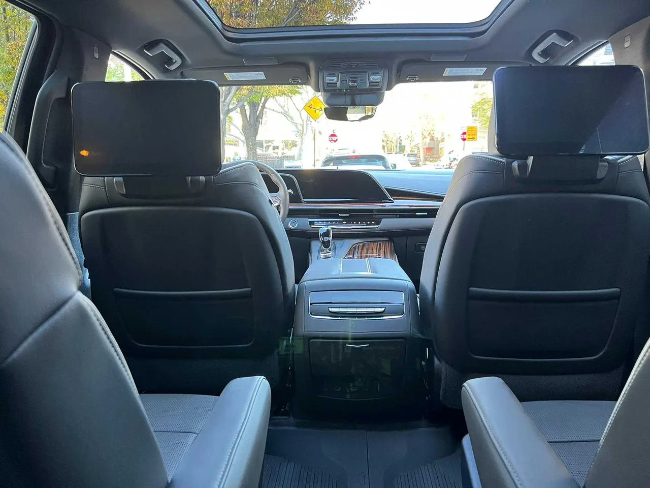 Cadillac Escalade interior with rear-seat entertainment screens for airport transfers in Miramonte, CA