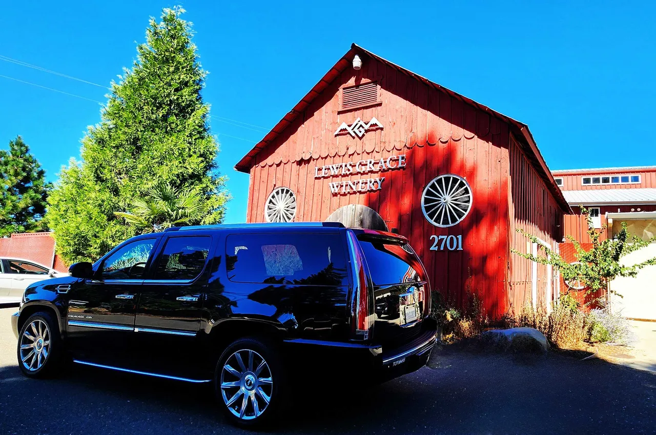 Black Cadillac Escalade ESV with tinted windows and running boards for airport transfers in Elverta, CA