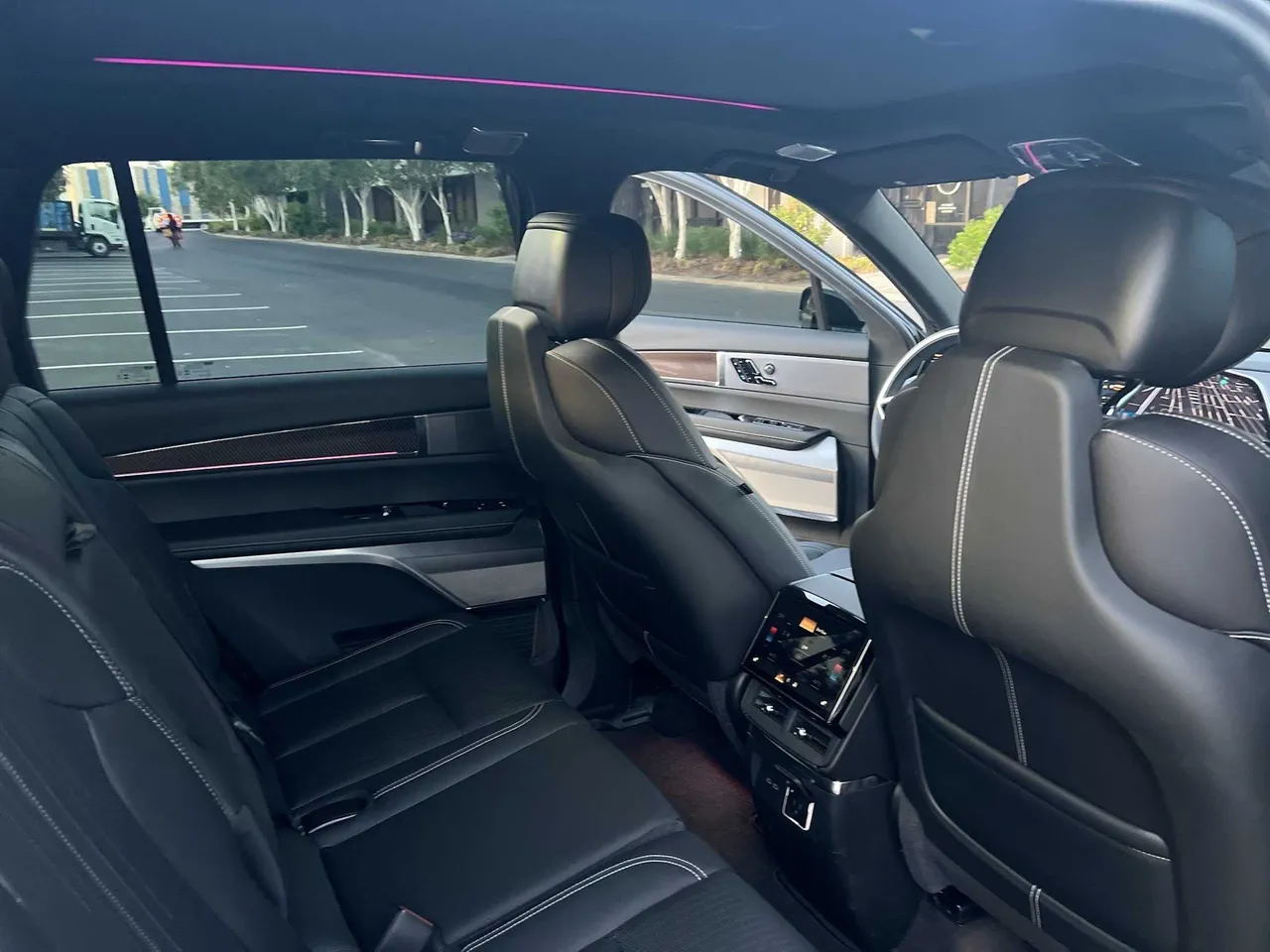 CADILLAC Vistiq EV interior with rear passenger controls and LED accent lighting for airport transfers in Montara, CA