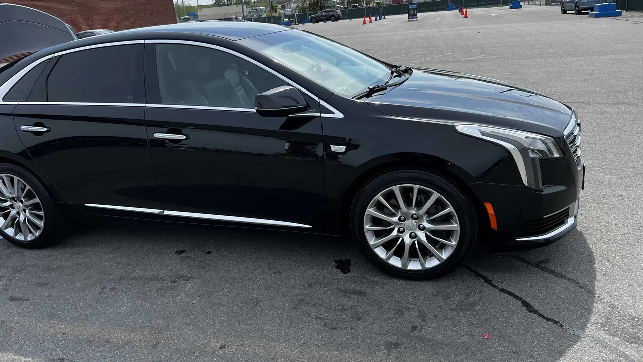 Black Cadillac XTS for sedan rental in Sheldon, VT