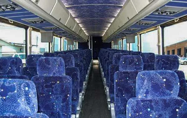 55 Passenger Charter Bus interior with overhead parcel racks for charter bus rental