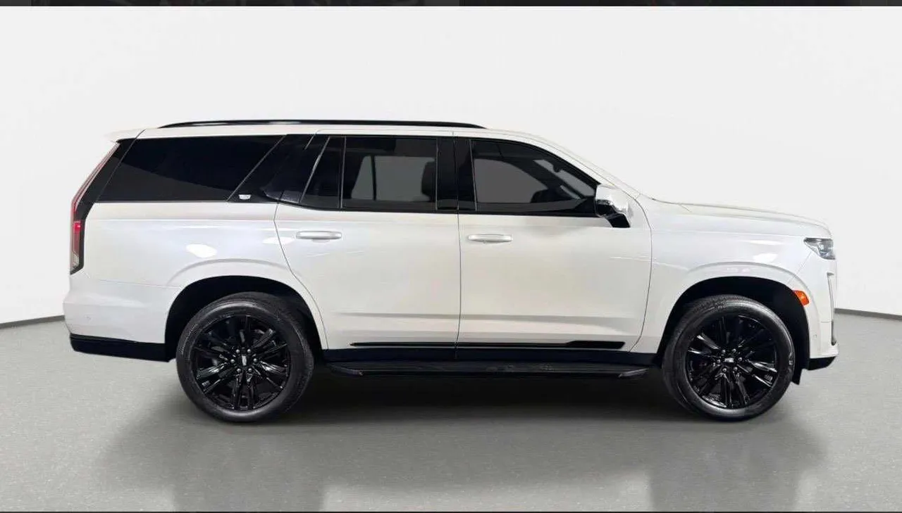 White Cadillac Escalade Platinum exterior for airport transfers White Cadillac Escalade Platinum exterior for airport transfers