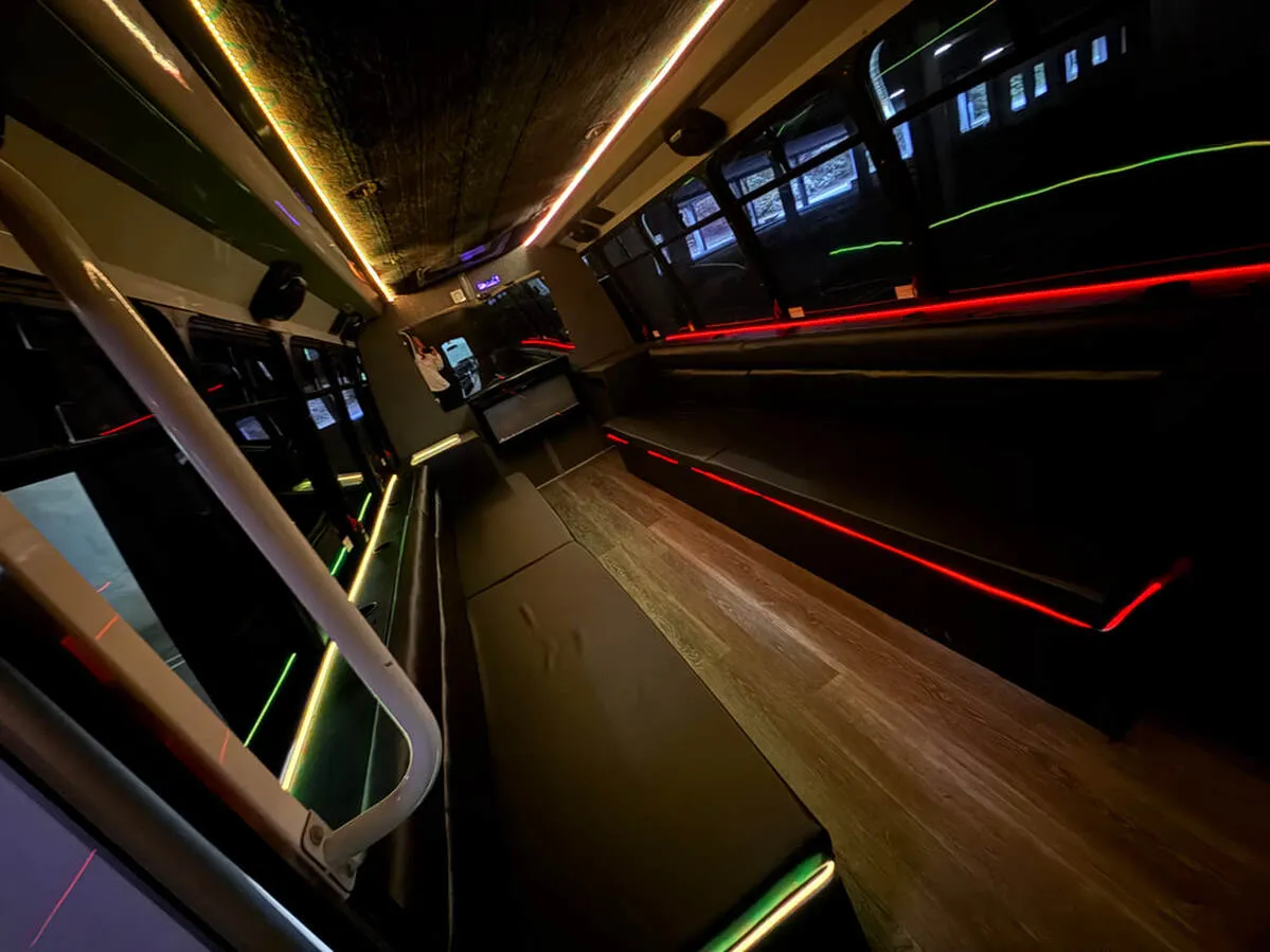 Ford E-450 Series Party Bus interior with perimeter lounge seating, LED accent lighting and LED ceiling lighting, photo 2 for party bus rental Ford E-450 Series Party Bus interior with perimeter lounge seating, LED accent lighting and LED ceiling lighting, photo 2 for party bus rental