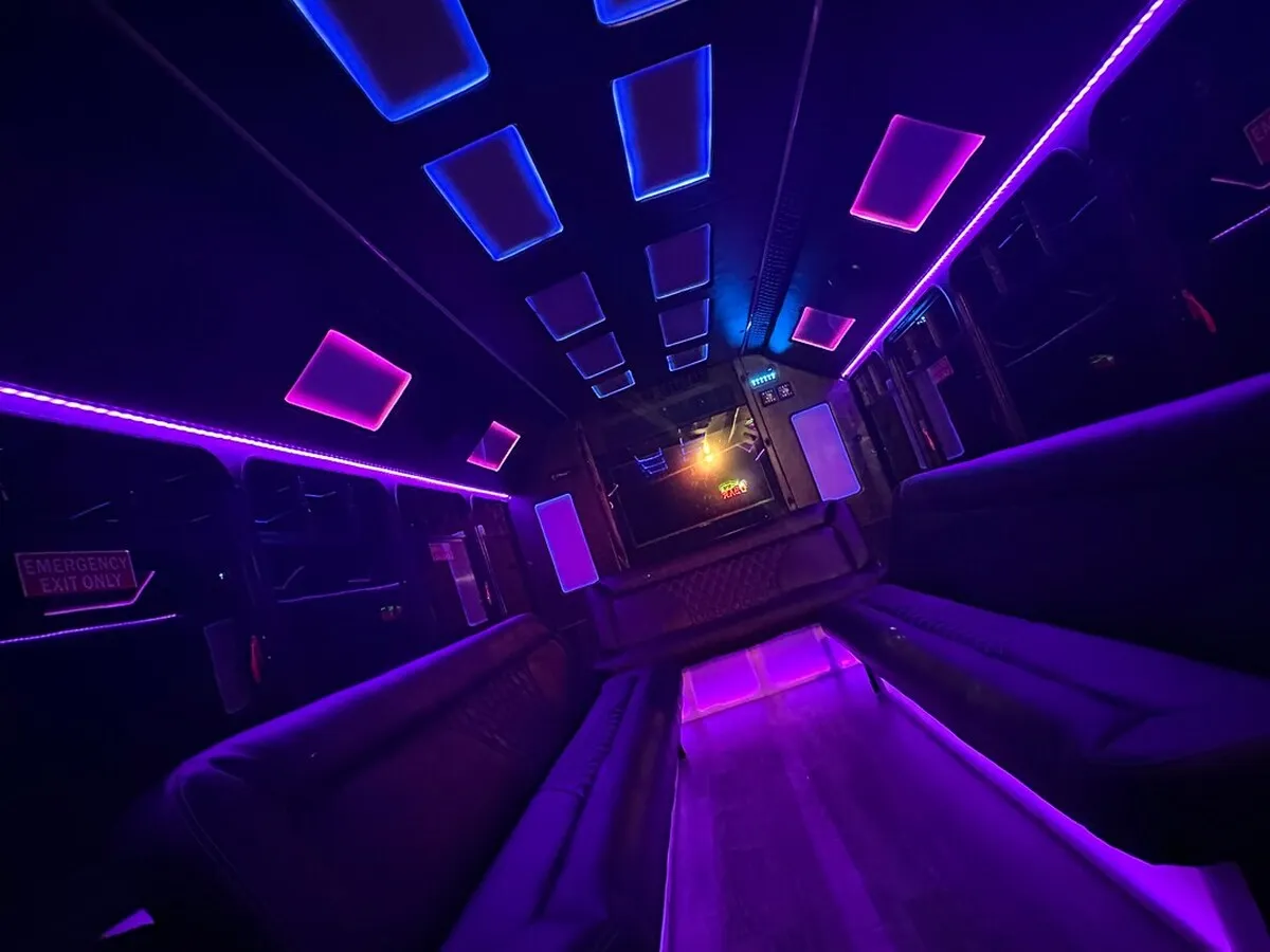 Ford E-450 Series Party Bus interior with perimeter lounge seating, LED accent lighting and LED ceiling lighting, photo 3 for party bus rental Ford E-450 Series Party Bus interior with perimeter lounge seating, LED accent lighting and LED ceiling lighting, photo 3 for party bus rental