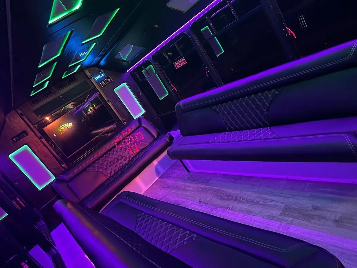 Ford E-450 Series Party Bus interior with perimeter lounge seating, LED accent lighting and LED ceiling lighting, photo 4 for party bus rental Ford E-450 Series Party Bus interior with perimeter lounge seating, LED accent lighting and LED ceiling lighting, photo 4 for party bus rental