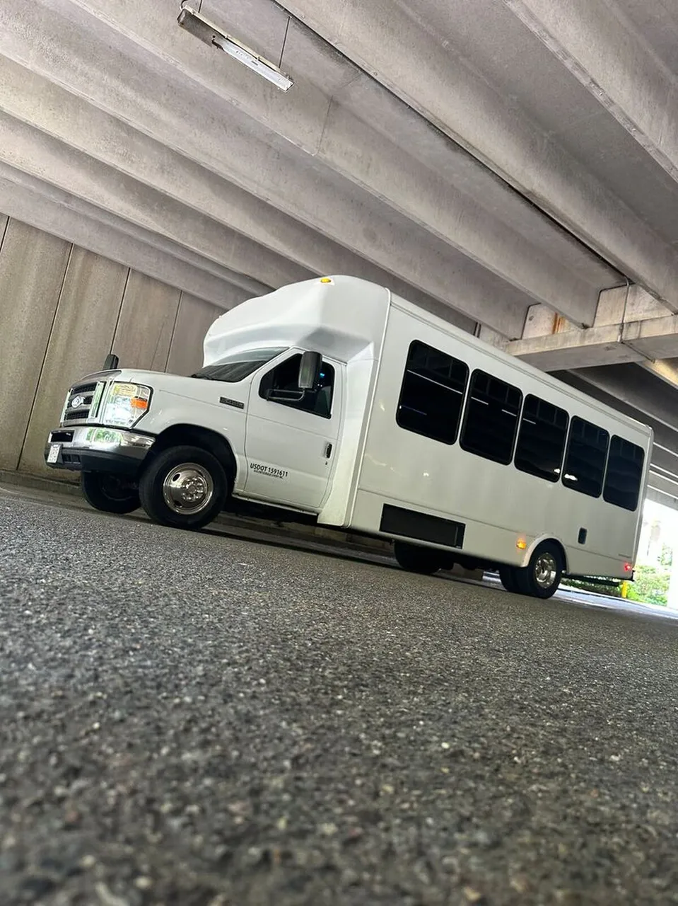 White Ford E-450 Series Party Bus exterior with tinted windows, photo 10 for party bus rental in North Attleboro, MA