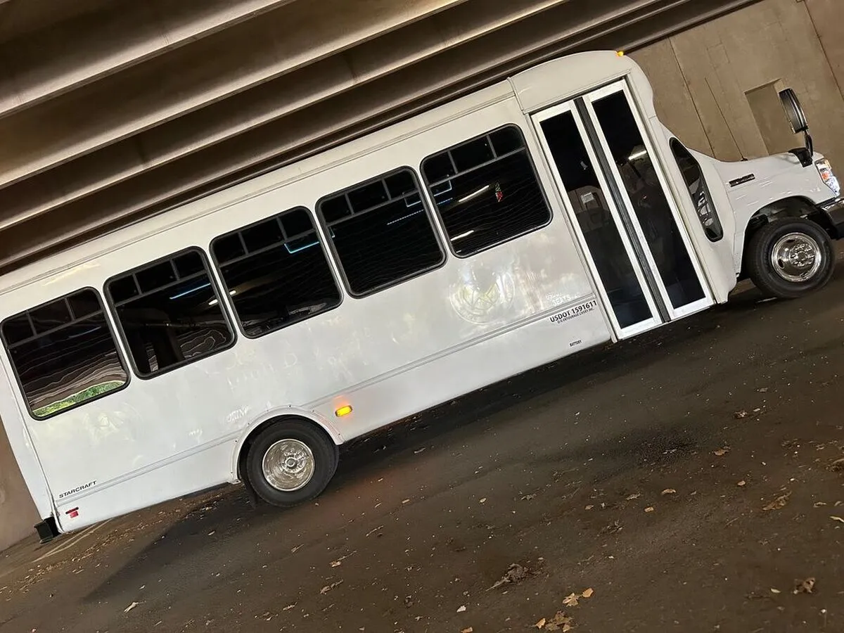 White Ford E-450 Series Party Bus exterior with tinted windows for party bus rental White Ford E-450 Series Party Bus exterior with tinted windows for party bus rental