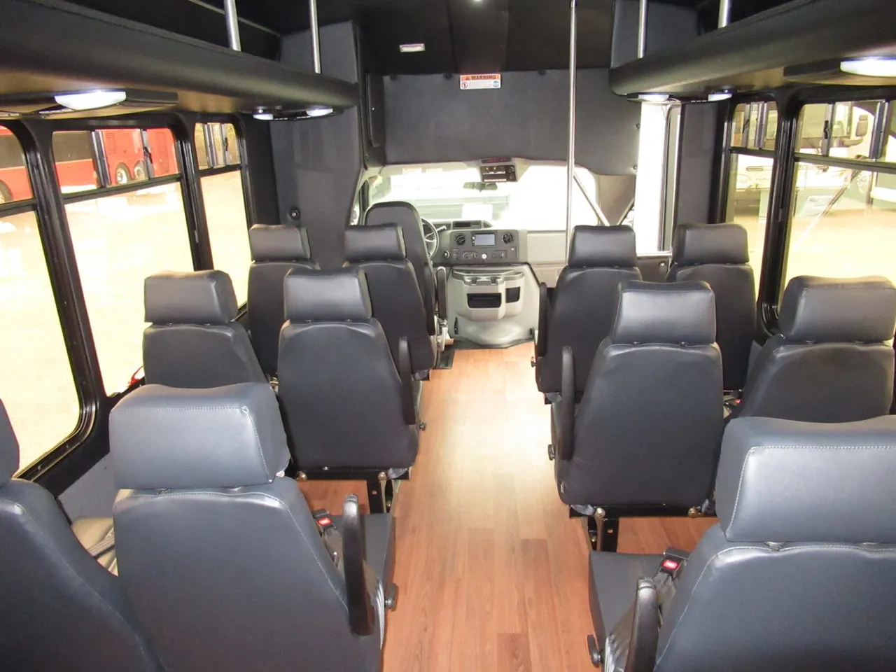 24 Passenger Ford E450 Executive VIP Shuttle Bus interior with wood-look flooring, photo 2 for charter bus rental in Kenmore, WA