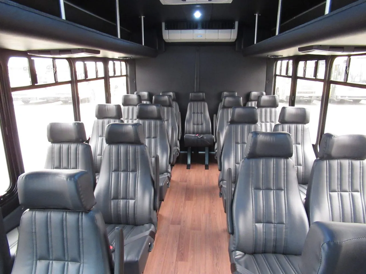 FORD F550 Executive VIP Mini Coach (28 Passenger) interior with wood-look flooring for winery tour transport in Washington