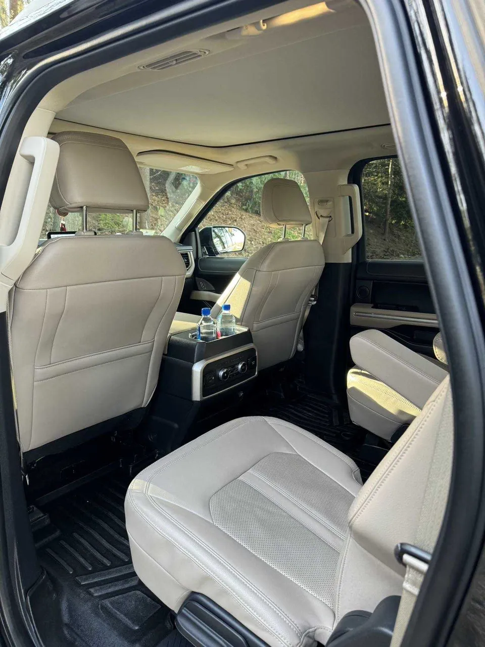 Ford Expedition MAX interior with captain's chairs and cup holders for chauffeur car rental in Tamworth, NH
