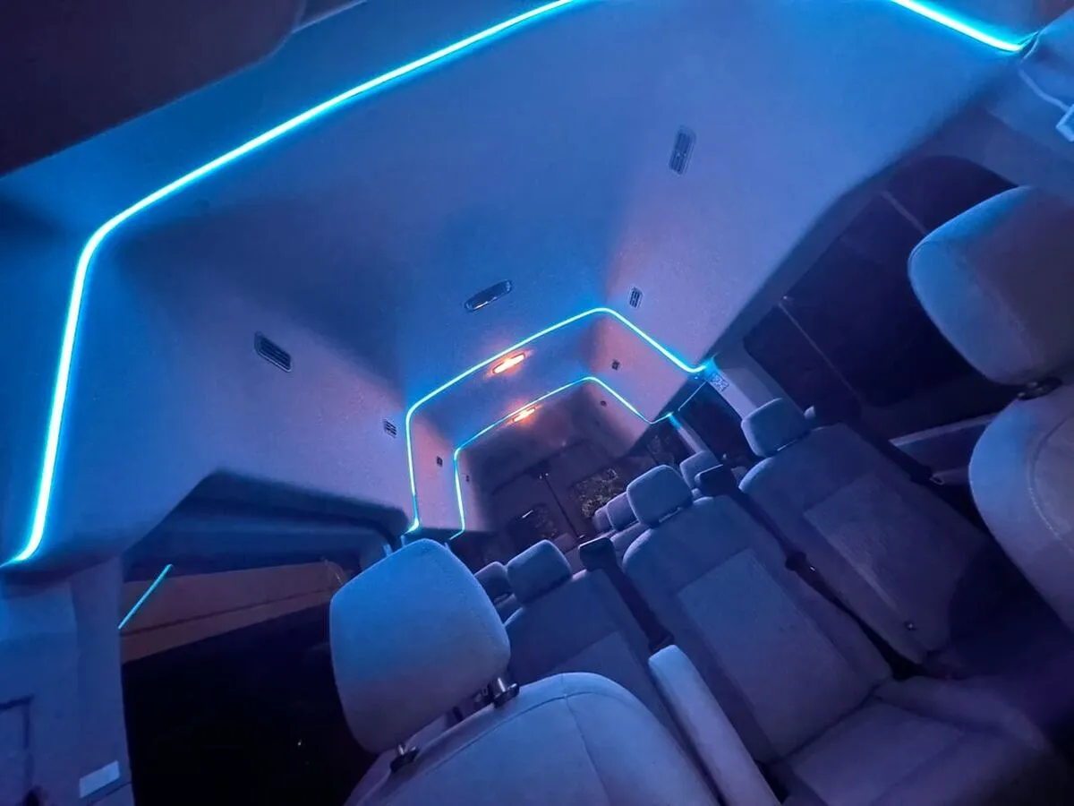 Ford Transit Van interior with high-roof cabin and LED ceiling lighting for minibus rental Ford Transit Van interior with high-roof cabin and LED ceiling lighting for minibus rental