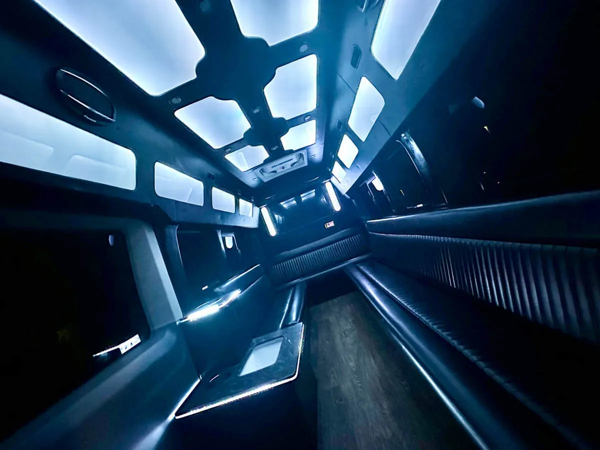 Ford Transit Van interior with perimeter lounge seating, LED accent lighting and LED ceiling lighting for party bus rental Ford Transit Van interior with perimeter lounge seating, LED accent lighting and LED ceiling lighting for party bus rental