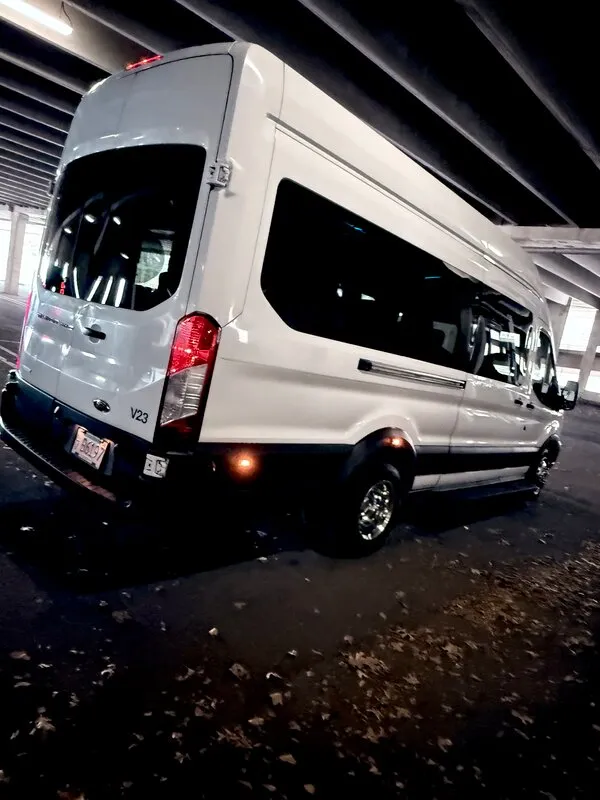 White Ford Transit VAN exterior with tinted windows for mini coach rental in Medfield, MA