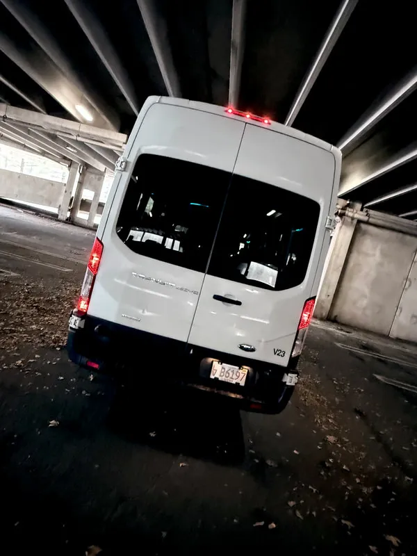 White Ford Transit VAN exterior with tinted windows, photo 6 for mini coach rental in Medfield, MA