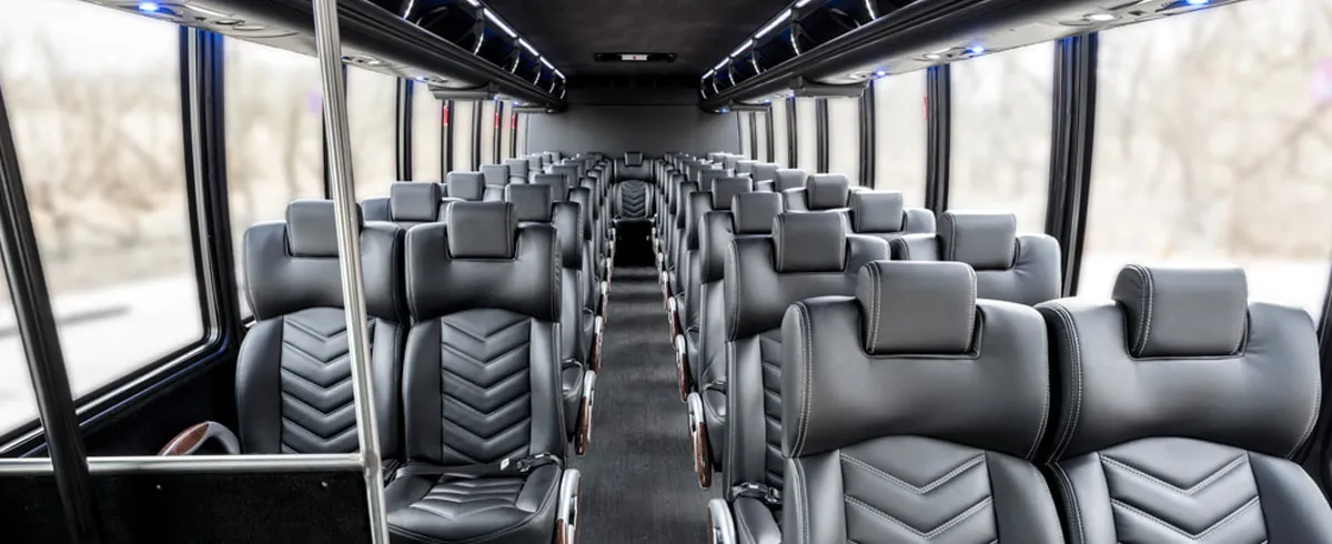 Freightliner 40 Passenger Shuttle Bus (Black) interior with airline-style seats and grab handles and rails for minibus rental Freightliner 40 Passenger Shuttle Bus (Black) interior with airline-style seats and grab handles and rails for minibus rental