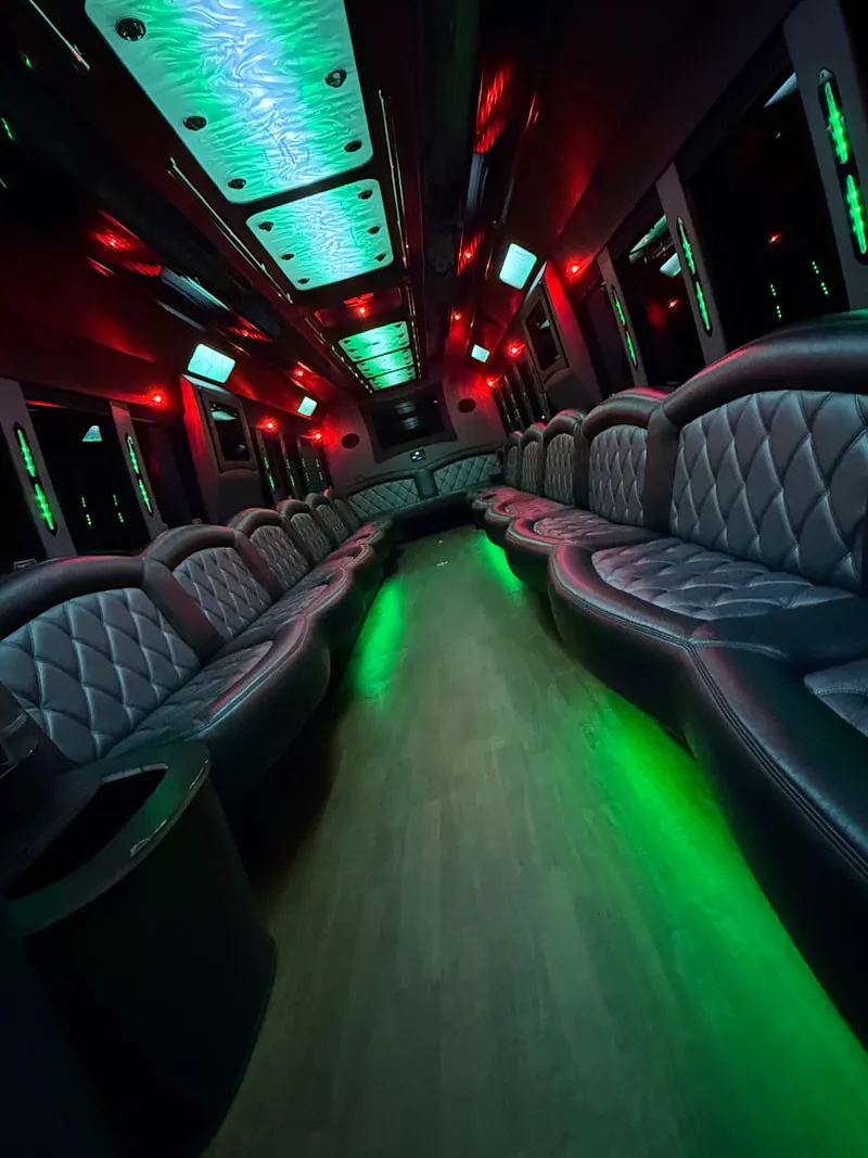 Freightliner Party Bus interior with perimeter lounge seating, LED ceiling lighting and wood-look flooring, photo 10 for party bus rental in North Attleboro, MA Freightliner Party Bus interior with perimeter lounge seating, LED ceiling lighting and wood-look flooring, photo 10 for party bus rental in North Attleboro, MA