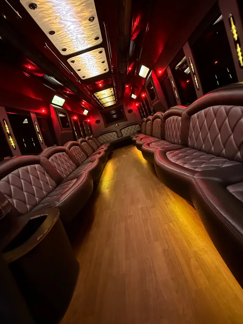 Freightliner Party Bus interior with perimeter lounge seating, LED ceiling lighting and wood-look flooring, photo 12 for party bus rental in North Attleboro, MA Freightliner Party Bus interior with perimeter lounge seating, LED ceiling lighting and wood-look flooring, photo 12 for party bus rental in North Attleboro, MA