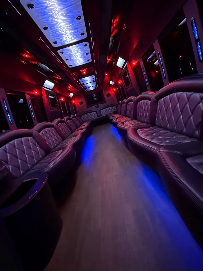 Freightliner Party Bus interior with perimeter lounge seating, LED ceiling lighting and wood-look flooring, photo 8 for party bus rental in North Attleboro, MA Freightliner Party Bus interior with perimeter lounge seating, LED ceiling lighting and wood-look flooring, photo 8 for party bus rental in North Attleboro, MA