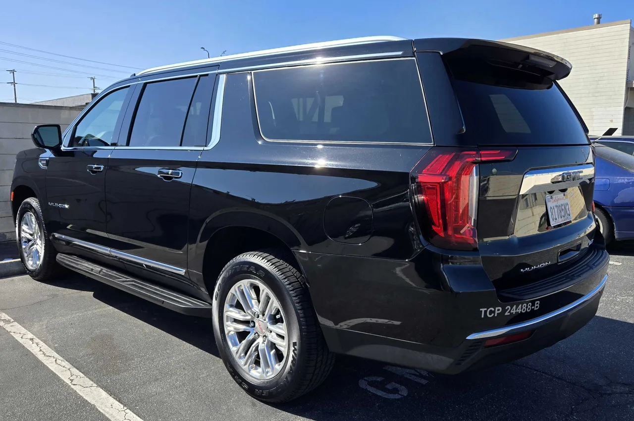 Black GMC Yukon exterior with running boards for airport transfers in Wilmington, CA