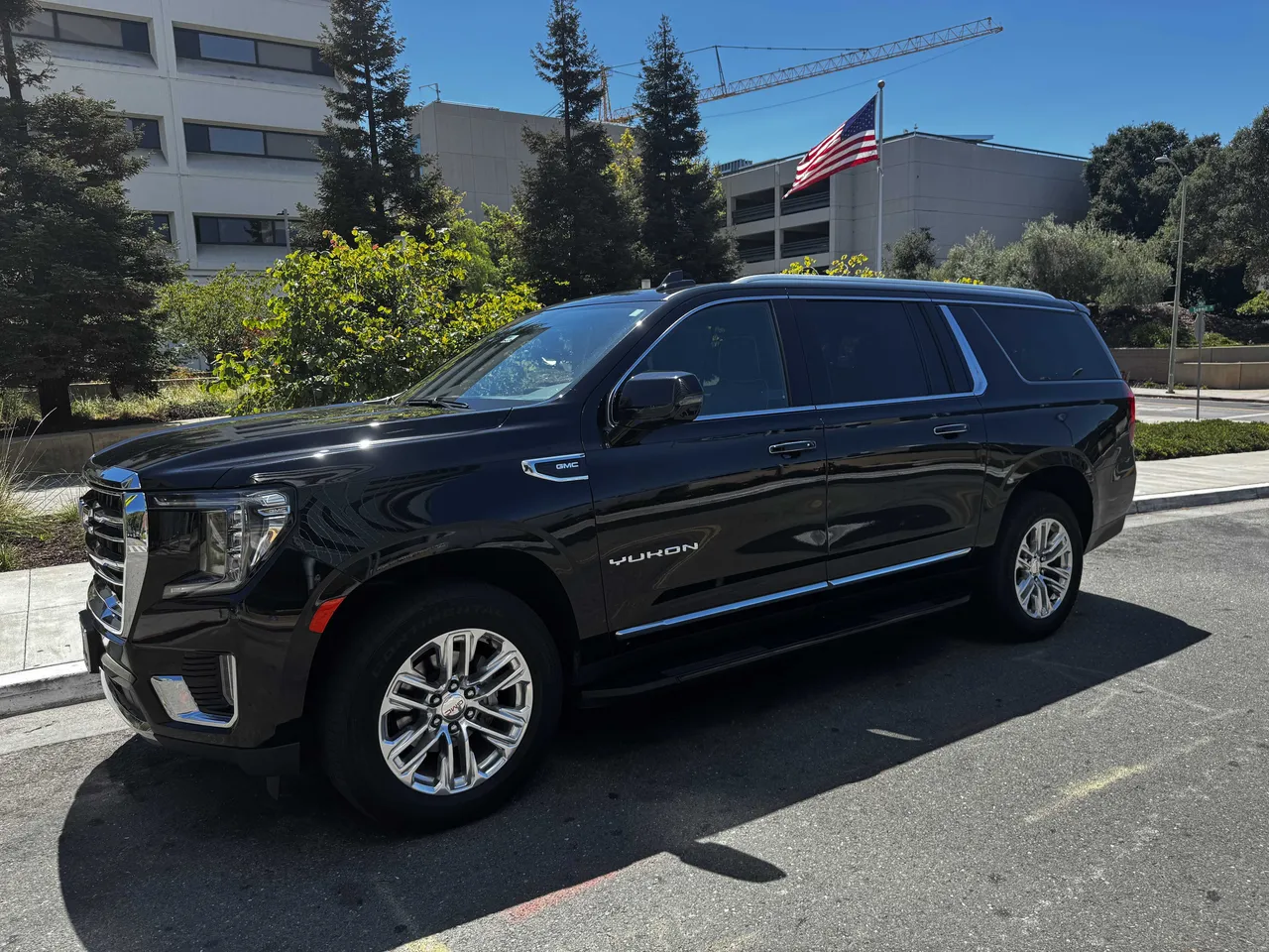 Black GMC Yukon with tinted windows and running boards for black car service in San Mateo County, CA