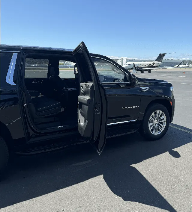 Black GMC Yukon XL exterior with running boards for black car service in Seattle, WA