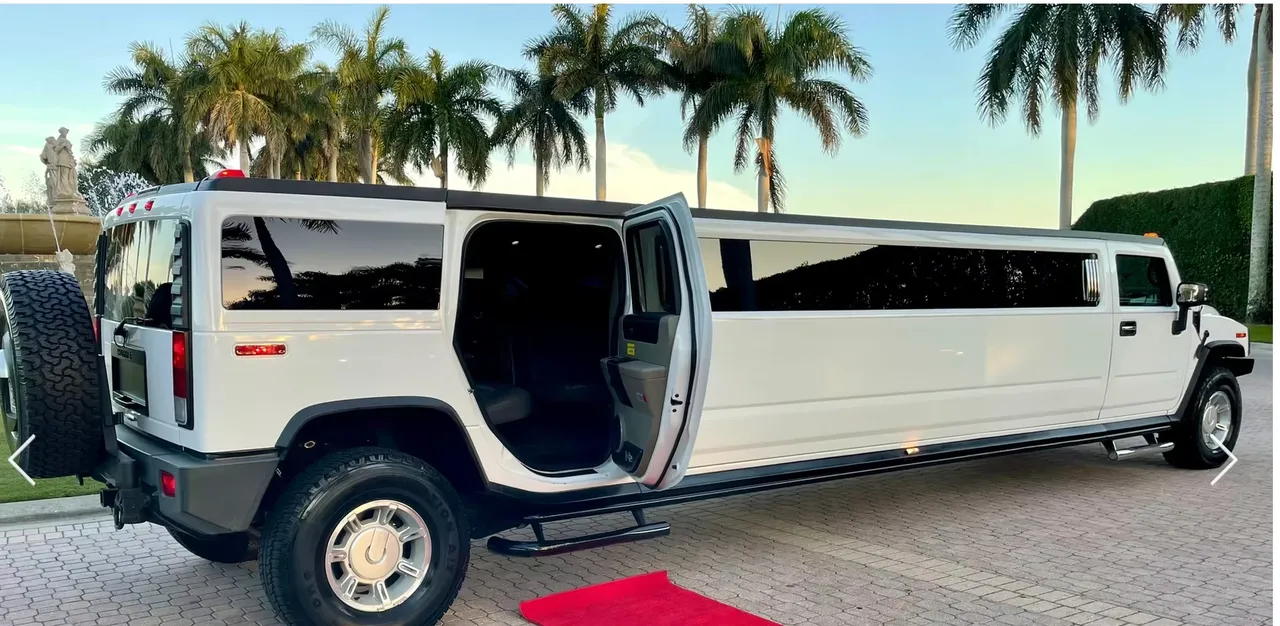White Hummer H2 15 Pass with tinted windows and running boards for hummer limo rental in Appling County, GA