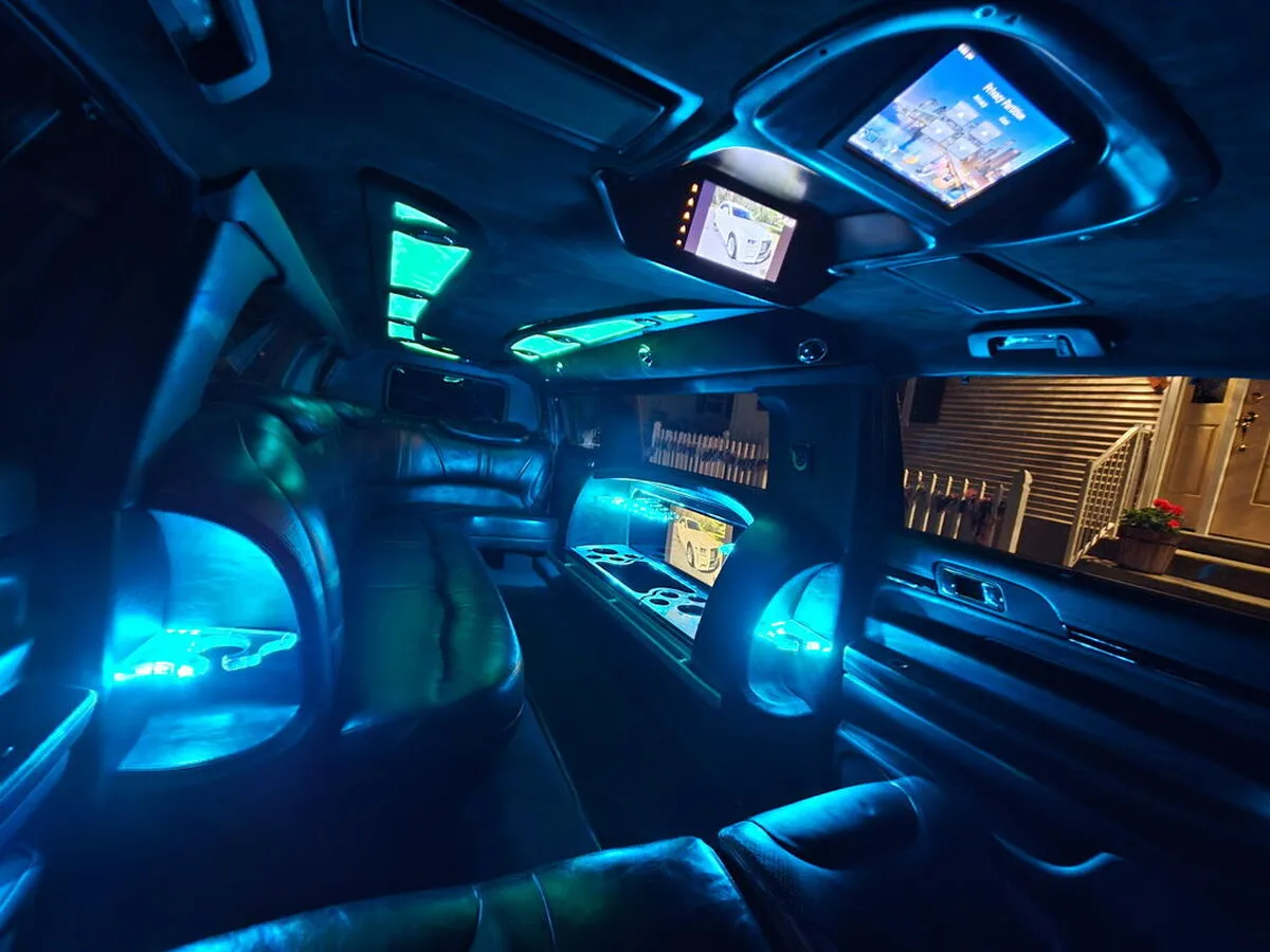 Lincoln MKT Limousine interior with LED accent lighting and TV screens for limo rental in Colorado