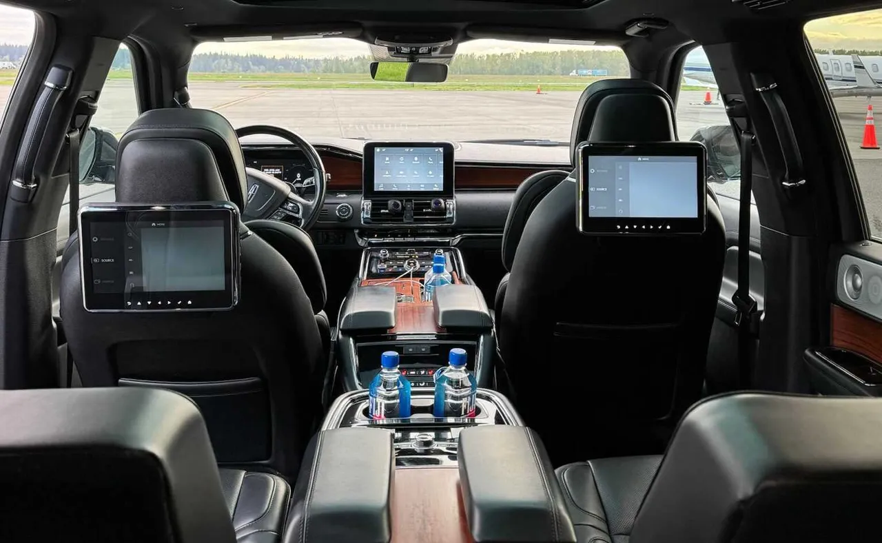 Lincoln Navigator interior with cup holders and rear-seat entertainment screens for airport transfers in Smith River, CA