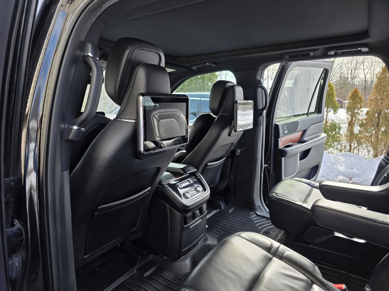 Lincoln Navigator interior with rear passenger controls and rear-seat entertainment screens for airport transfers