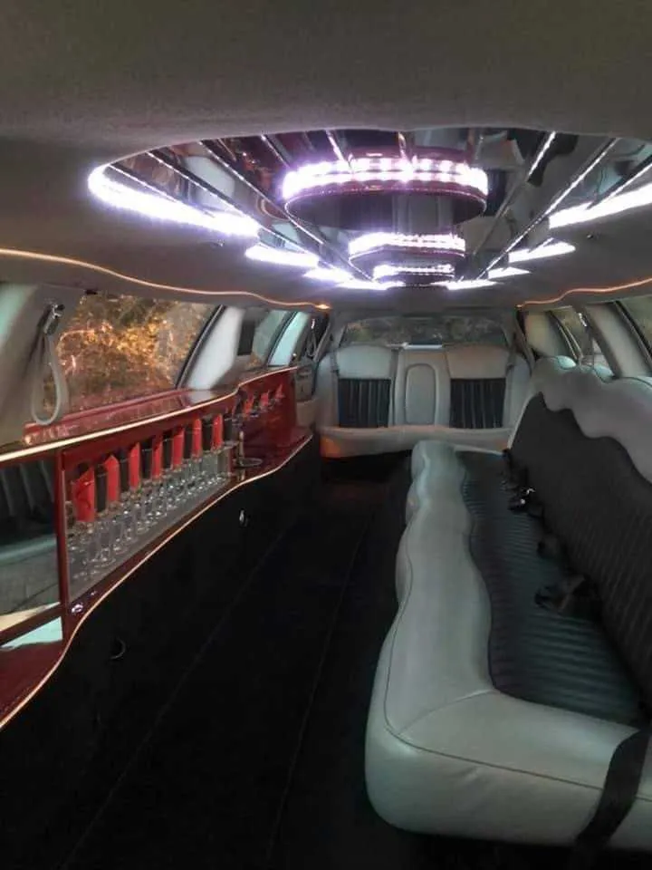 Lincoln Town Car interior with LED ceiling lighting and bar area for limo rental Lincoln Town Car interior with LED ceiling lighting and bar area for limo rental