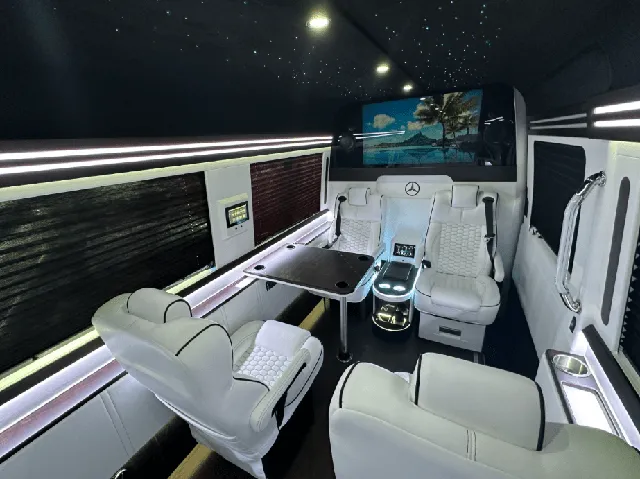 Luxury Mercedes Sprinter interior with captain's chairs, passenger tables and window shades, photo 2 for winery tour transport in New Braunfels, TX