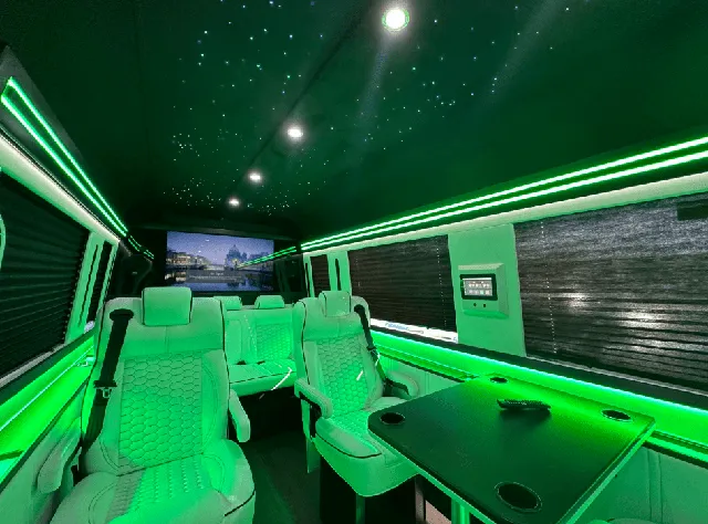 Luxury Mercedes Sprinter interior with captain's chairs, passenger tables and window shades for winery tour transport in New Braunfels, TX