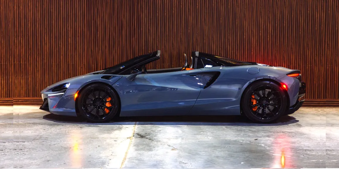 Gray McLaren Artura exterior with convertible roof for sports car rental Gray McLaren Artura exterior with convertible roof for sports car rental