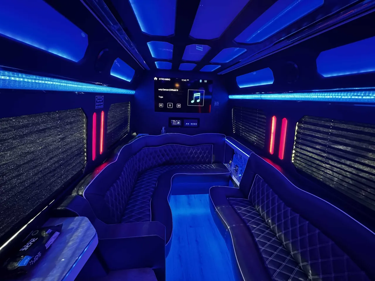 Mercedes-Benz Sprinter Party Limousine Bus interior with perimeter lounge seating, sofa-style seating and passenger tables for bachelorette party transport in Newbury Park, CA Mercedes-Benz Sprinter Party Limousine Bus interior with perimeter lounge seating, sofa-style seating and passenger tables for bachelorette party transport in Newbury Park, CA
